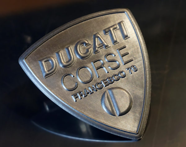 Customized Ducati Corse logo in aluminium